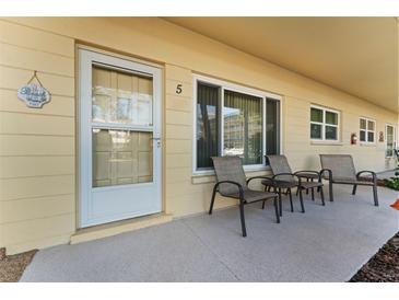 Inviting front patio with seating for three, perfect for relaxing at 2459 Franciscan Dr # 5, Clearwater, FL 33763