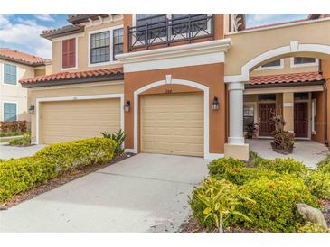 Two-story townhome with double garage and landscaped front at 284 Crew Ct, Sarasota, FL 34243