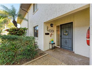 Inviting entryway with a welcoming wreath and landscaping at 3500 El Conquistador Pkwy # 119, Bradenton, FL 34210