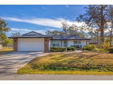 White single-story house with attached garage and landscaped yard at 3762 San Luis Dr, Sarasota, FL 34235