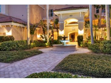 Elegant courtyard entry with fountain and lush landscaping at 393 N Point Rd # 604, Osprey, FL 34229