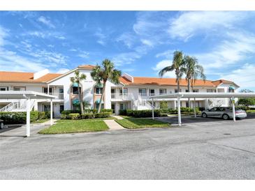 Condo building exterior with parking and landscaping at 4302 Madeira Ct # 3334, Sarasota, FL 34233