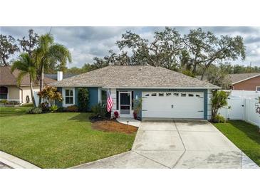 Charming single-story home with a well-maintained lawn and attached garage at 5424 81St Avenue E Cir, Palmetto, FL 34221