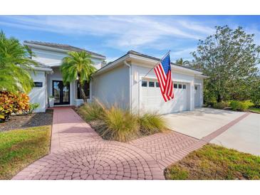 Beautiful home exterior with a two-car garage and manicured landscaping at 6669 Windjammer Pl, Lakewood Ranch, FL 34202