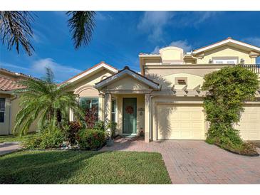 Beautiful 2 story home with lush landscaping and a brick paved driveway at 1152 Beachcomber Ct # 15, Osprey, FL 34229