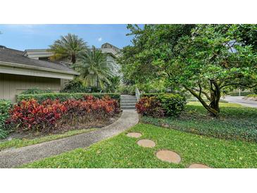 Landscaped front yard with walkway leading to home entrance at 1423 Kimlira Ln, Sarasota, FL 34231