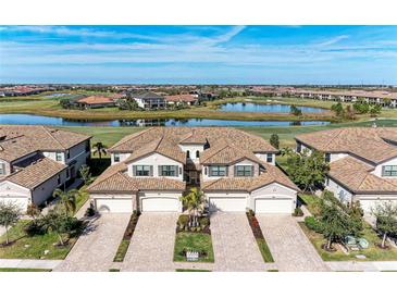 Luxury homes with tile roofs, situated around a golf course and lake at 18017 Gawthrop Dr # 101, Bradenton, FL 34211