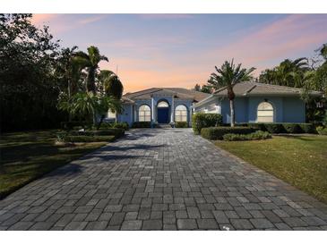 Stunning curb appeal with a paved driveway and lush landscaping at 1854 Amberwynd W Cir, Palmetto, FL 34221