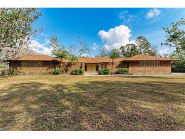 Brick ranch house with a large yard and mature trees at 2119 Zipperer Rd, Bradenton, FL 34212