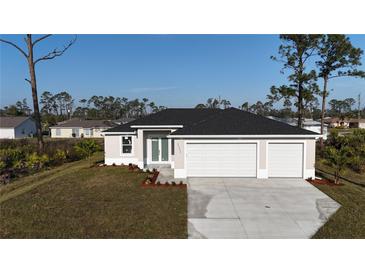 Charming single-Gathering home with a three car garage and manicured lawn at 2323 Zuyder Ter, North Port, FL 34286