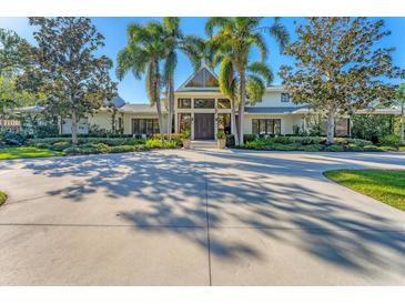 Stunning curb appeal, featuring a spacious driveway and lush landscaping at 3709 Beneva Oaks Way, Sarasota, FL 34238