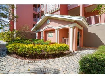 Inviting building entrance with landscaped grounds at 5250 Manorwood Dr # 4A, Sarasota, FL 34235