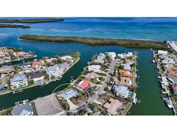 Aerial view of waterfront home with private dock and canal access at 721 Old Compass Rd, Longboat Key, FL 34228