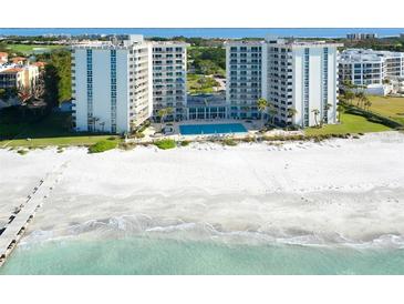 Aerial view of a beachfront condo building with a pool and beach access at 2295 Gulf Of Mexico Dr # 115S, Longboat Key, FL 34228