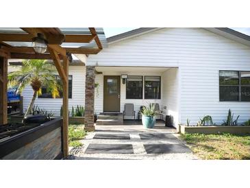 Modern white house with a landscaped front yard and paved driveway at 2606 19Th St, Sarasota, FL 34234