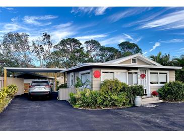 Cute bungalow with carport, nicely landscaped, and a spacious driveway at 4019 Worcester Rd, Sarasota, FL 34231