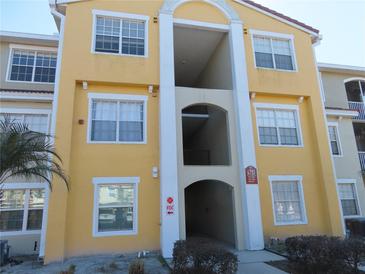 Condo building exterior featuring a yellow facade and multiple windows at 4751 Travini Cir # 4-108, Sarasota, FL 34235