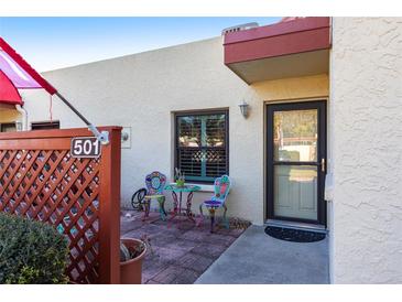 Inviting patio with colorful furniture and wooden privacy screen at 501 Spring Lakes Blvd # 501, Bradenton, FL 34210