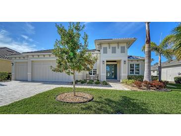 Beautiful two-story house with a landscaped yard and two-car garage at 7087 Tamworth Pkwy, Sarasota, FL 34241