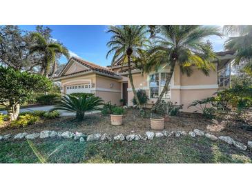 Beautiful house exterior, featuring a two-car garage and lush landscaping at 7349 Windemere Ln, University Park, FL 34201