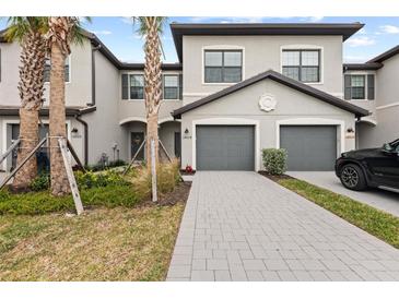 Two-story townhome with gray exterior, two-car garage, and paved driveway at 14824 Lyla Ter, Bradenton, FL 34211