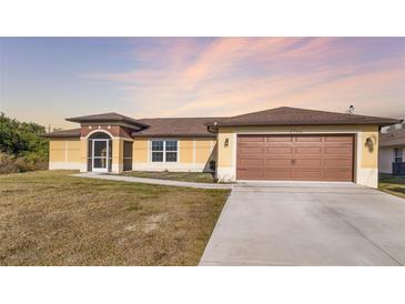 Single-story house with a brown garage door and screened porch at 1790 S Biscayne Dr, North Port, FL 34287