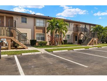 Two-story condo building with parking and landscaping at 25100 Sandhill Blvd # 102, Punta Gorda, FL 33983