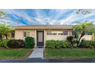 Condo building exterior showcasing landscaping and entrance at 2782 Woodgate Ln # 18, Sarasota, FL 34231