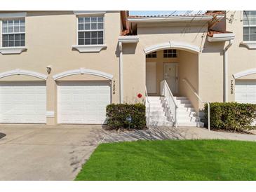 Charming townhome with a two-car garage, a well-kept lawn, and a welcoming entrance at 7254 Cedar Hollow Cir, Bradenton, FL 34203