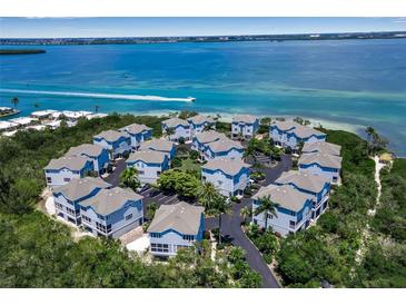 Aerial view of a waterfront community with numerous houses at 821 Evergreen Way, Longboat Key, FL 34228