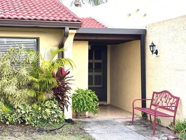 Inviting front entrance with red tile roof and landscaping at 1331 57Th W St # 1331, Bradenton, FL 34209