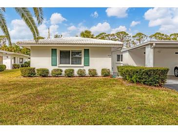 Single story home with green landscaping and carport at 1815 Vera Pl # 9, Sarasota, FL 34235