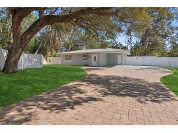 Landscaped front yard with brick paver driveway at 4485 17Th W St, Bradenton, FL 34207