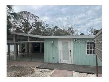 Light teal single story home with a deck and walkway at 4510 Banan Pl, Sarasota, FL 34242