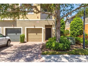 Inviting two-story townhome with a two-car garage and a well-maintained front yard at 7911 Moonstone Dr # 26-203, Sarasota, FL 34233