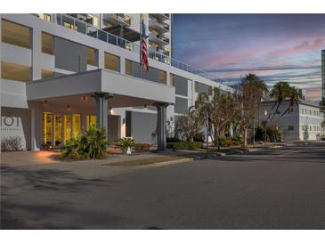 Modern condo building exterior at dusk, featuring a covered entrance and landscaping at 101 S Gulfstream Ave # 4F, Sarasota, FL 34236