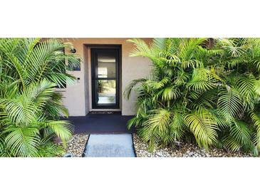 Inviting condo entrance with lush tropical landscaping at 2808 60Th W Ave # 403, Bradenton, FL 34207