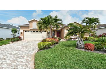 Tan one-story house with a two-car garage and lush landscaping at 4605 50Th W Ave, Bradenton, FL 34210