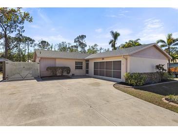 House exterior features a two-car garage and a large driveway at 6824 Jarvis Rd, Sarasota, FL 34241