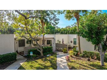 Attractive condo exterior with lush landscaping and private patio at 123 Pinehurst Dr, Bradenton, FL 34210