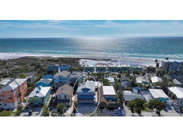 Aerial view of a charming beach house, near the ocean, with lush landscaping at 126/128 Avenida Veneccia, Sarasota, FL 34242