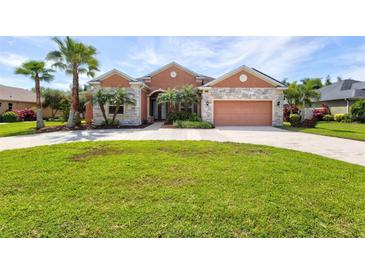 Beautiful one-story home with a large front yard and palm trees at 13207 49Th E Ln, Parrish, FL 34219