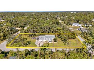 Aerial view of a single-Gathering home on a large lot with mature trees at 17402 Billiar Ave, Port Charlotte, FL 33948