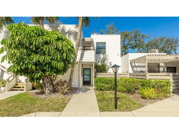 Inviting condo building exterior with lush landscaping and walkway at 307 Timberlake Dr # 307, Bradenton, FL 34210