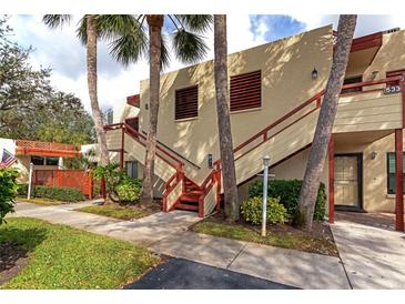 Condo building exterior with stairs and tropical landscaping at 535 Spring Lakes Blvd, Bradenton, FL 34210