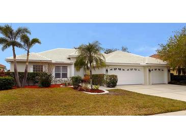 Single-story home with tile roof, two-car garage, and landscaped yard at 7212 Southgate Ct, Sarasota, FL 34243