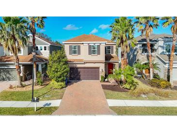 Two-story house with brown roof, red door, and brick driveway at 8267 Nandina Dr, Sarasota, FL 34240