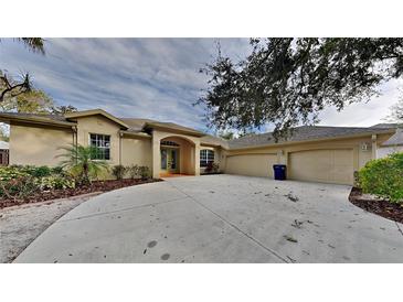 House exterior showcasing a three-car garage and well-manicured landscaping at 2914 112Th E Ter, Parrish, FL 34219