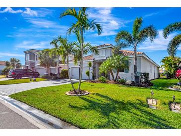 Beautiful two-story house with a tile driveway and lush landscaping at 3218 Big Sky Way, Bradenton, FL 34211