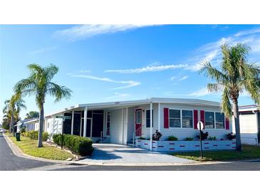 Well-maintained manufactured home with carport and landscaping at 3230 Banyan Ter, Sarasota, FL 34237